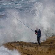 Fisherman escaping wave - Donald Gould